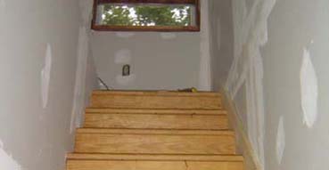 Looking up the stairs with drywall done