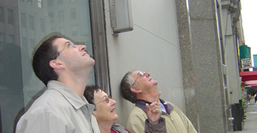 Damn tourists stare at Empire State Building.