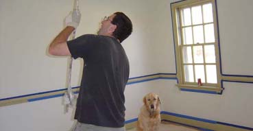 Painting the ceiling. Jake looks worried.